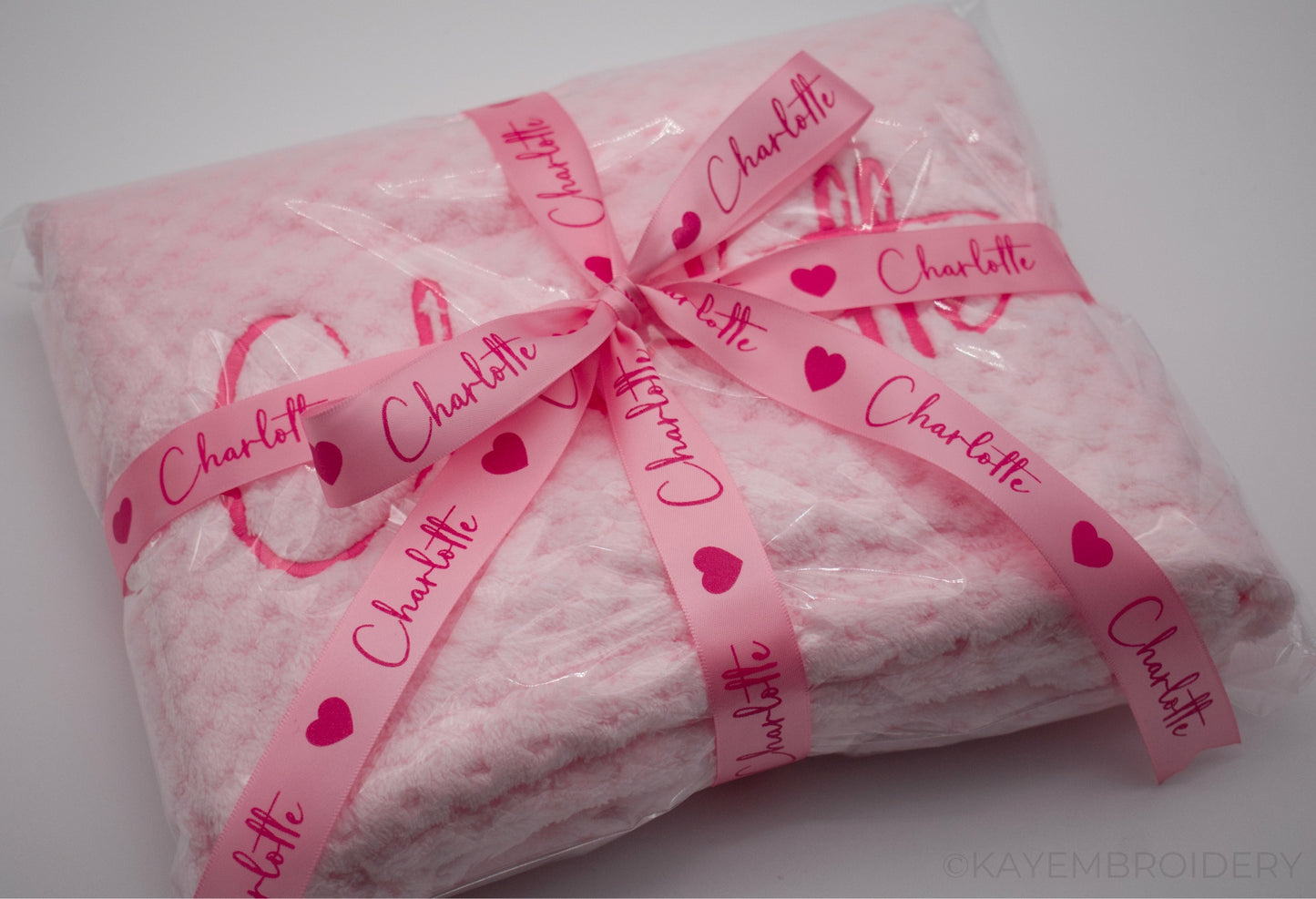 Embroidered Baby Waffle Blanket with name in Pink, embroidery is done in a darker shade gift wrapped with Ribbon
