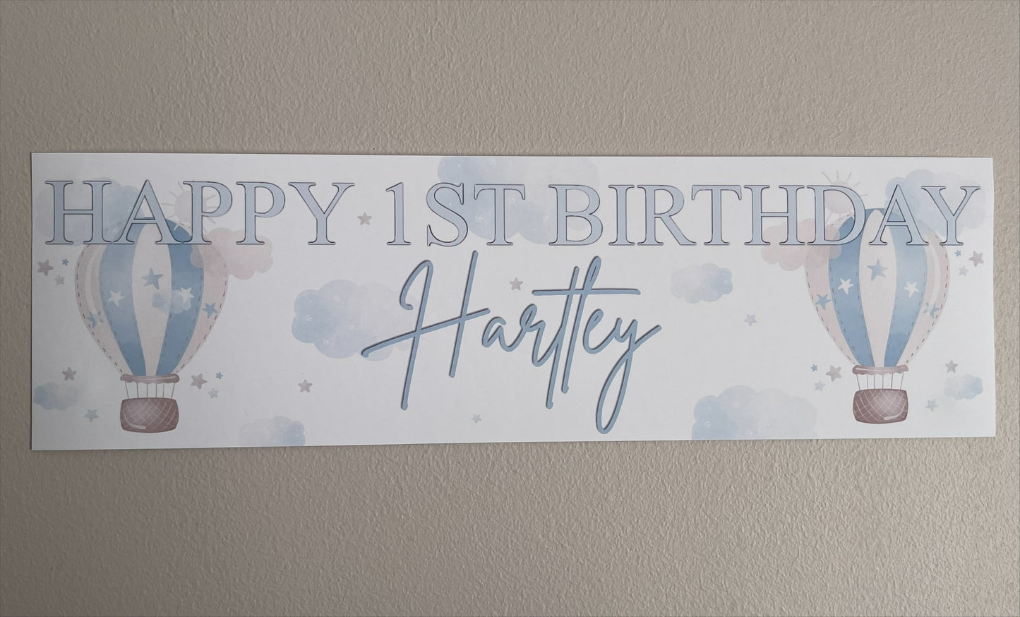 in the sky 1st birthday banner in blue personalised with happy 1st birthday and name