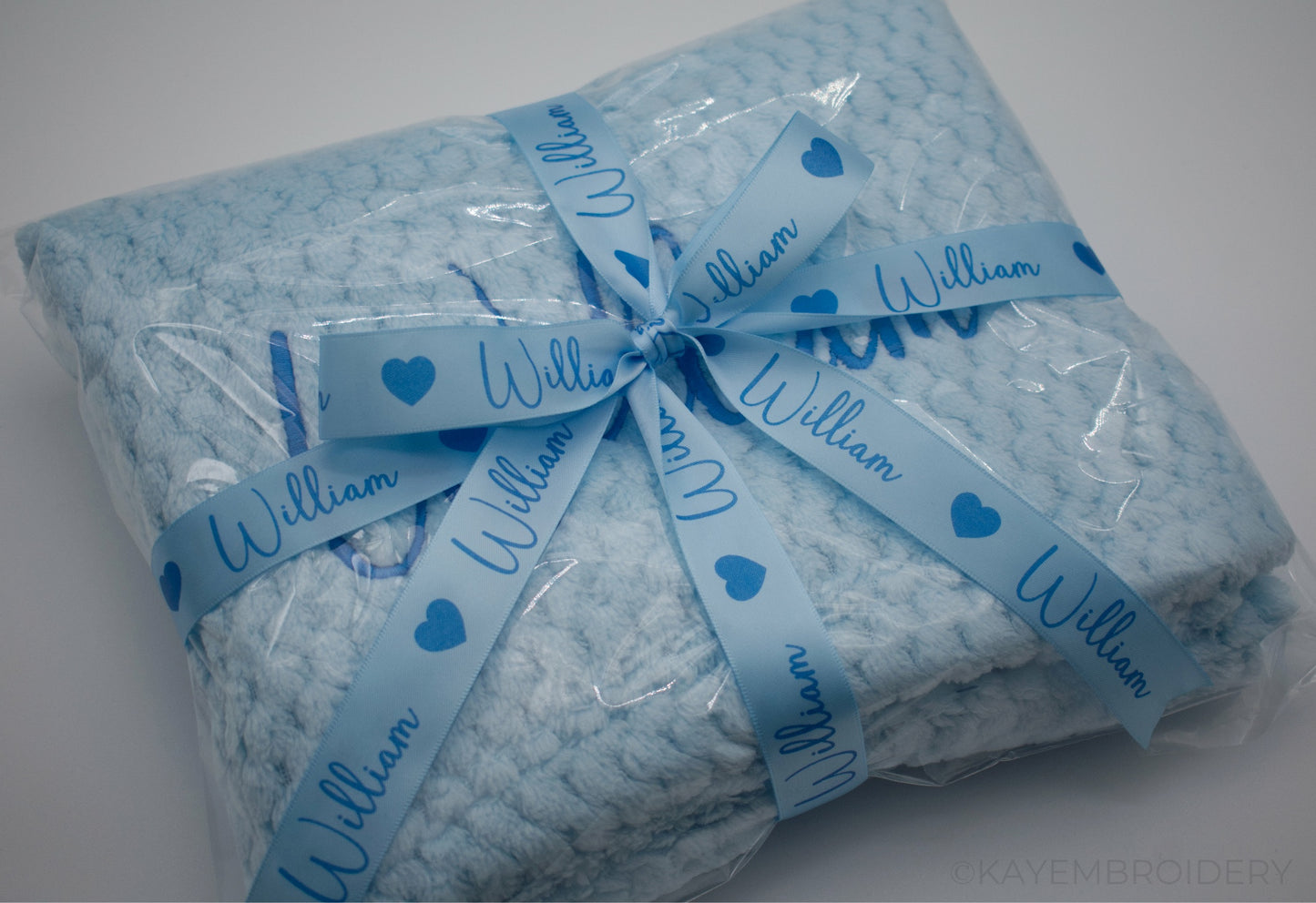 Embroidered Baby Waffle Blanket with name in Blue, embroidery is done in a darker shade gift wrapped with Ribbon