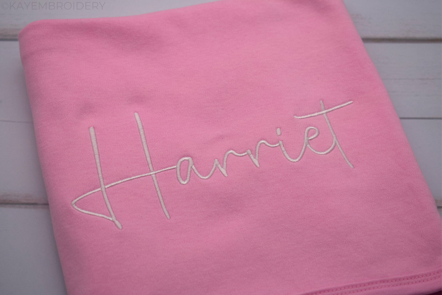 Close up name in white embroidery on Pink Cotton Baby Blanket
