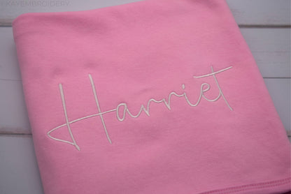 Close up name in white embroidery on Pink Cotton Baby Blanket