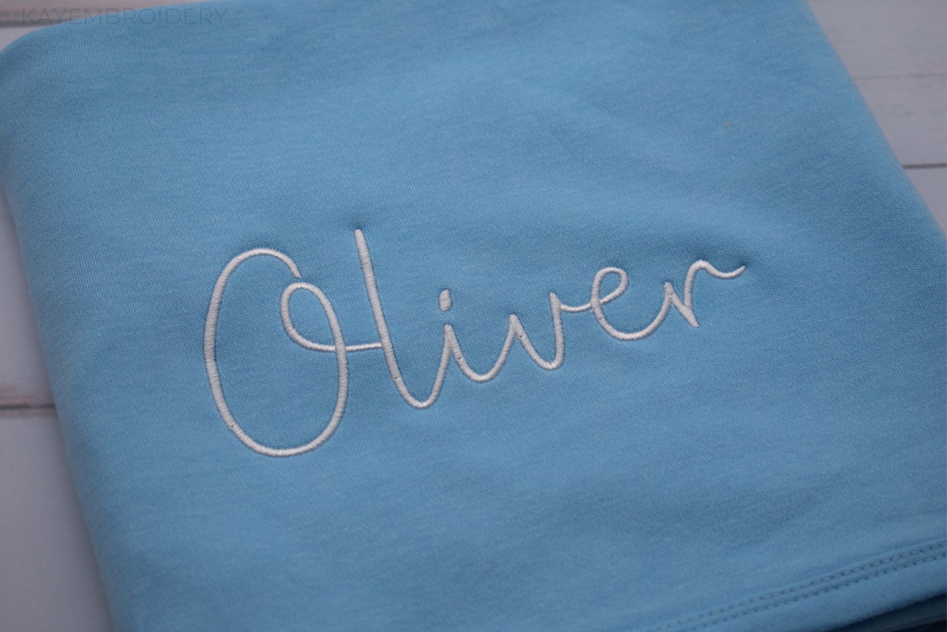 Close up name in white embroidery on Blue Cotton Baby Blanket