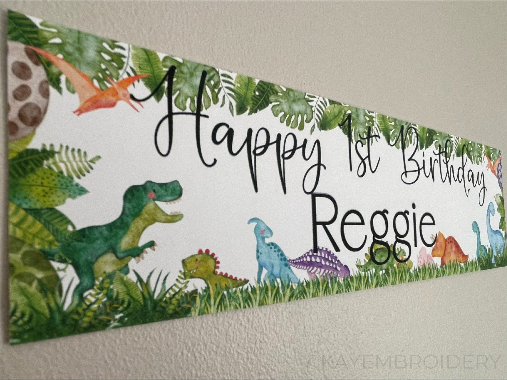 Birthday banners featuring a watercolour dinosaurs theme, t rex, triceratops, stegosaurus. Personalised with happy age birthday and name