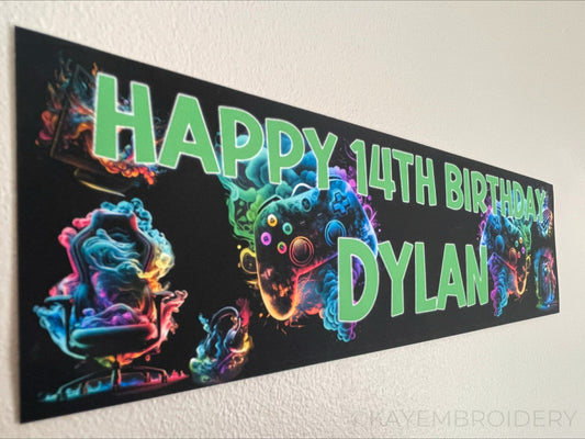birthday banner with multicolour controller, PC, Headphones, keyboard, Chair gaming theme personalised with name and age in Green Text