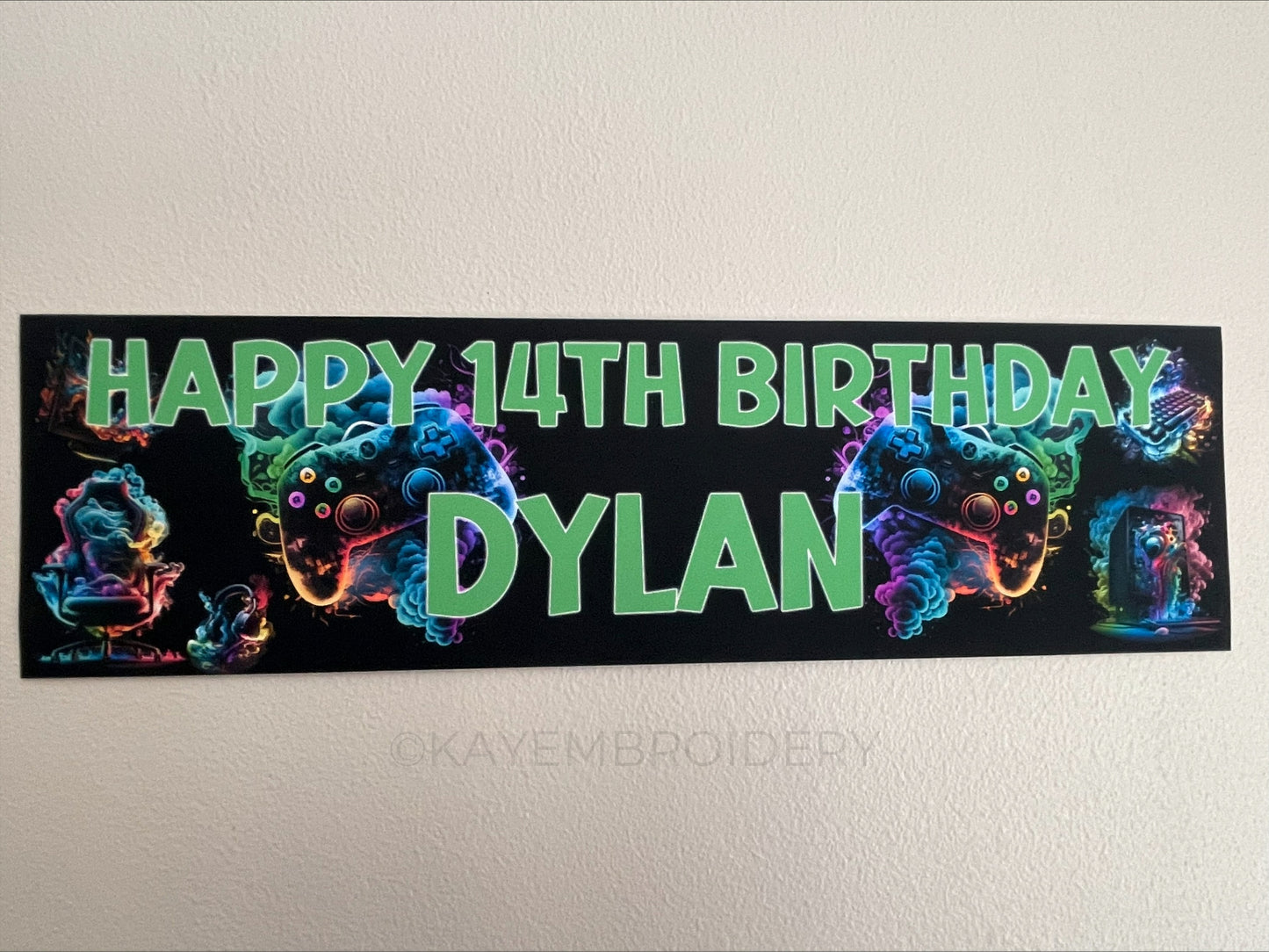 birthday banner with multicolour controller, PC, Headphones, keyboard, Chair gaming theme personalised with name and age in Green Text