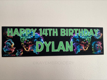 birthday banner with multicolour controller, PC, Headphones, keyboard, Chair gaming theme personalised with name and age in Green Text