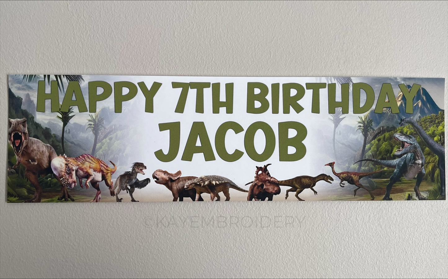 Birthday Banner with Dinosaurs set in Jurassic Background theme T rex, Triceratops, Stegosaurus, brontosaurus. Personalised with name and age in Green Text