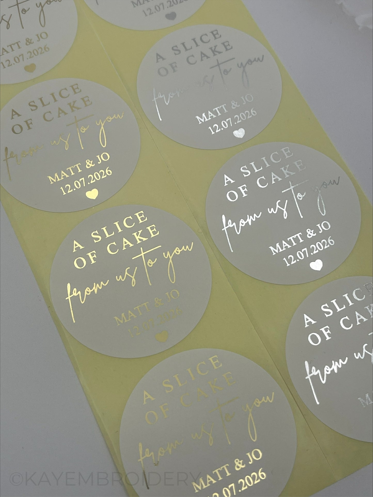 Close up of Wedding Cake thank you white Stickers foiled in gold or silver personalised with name and date