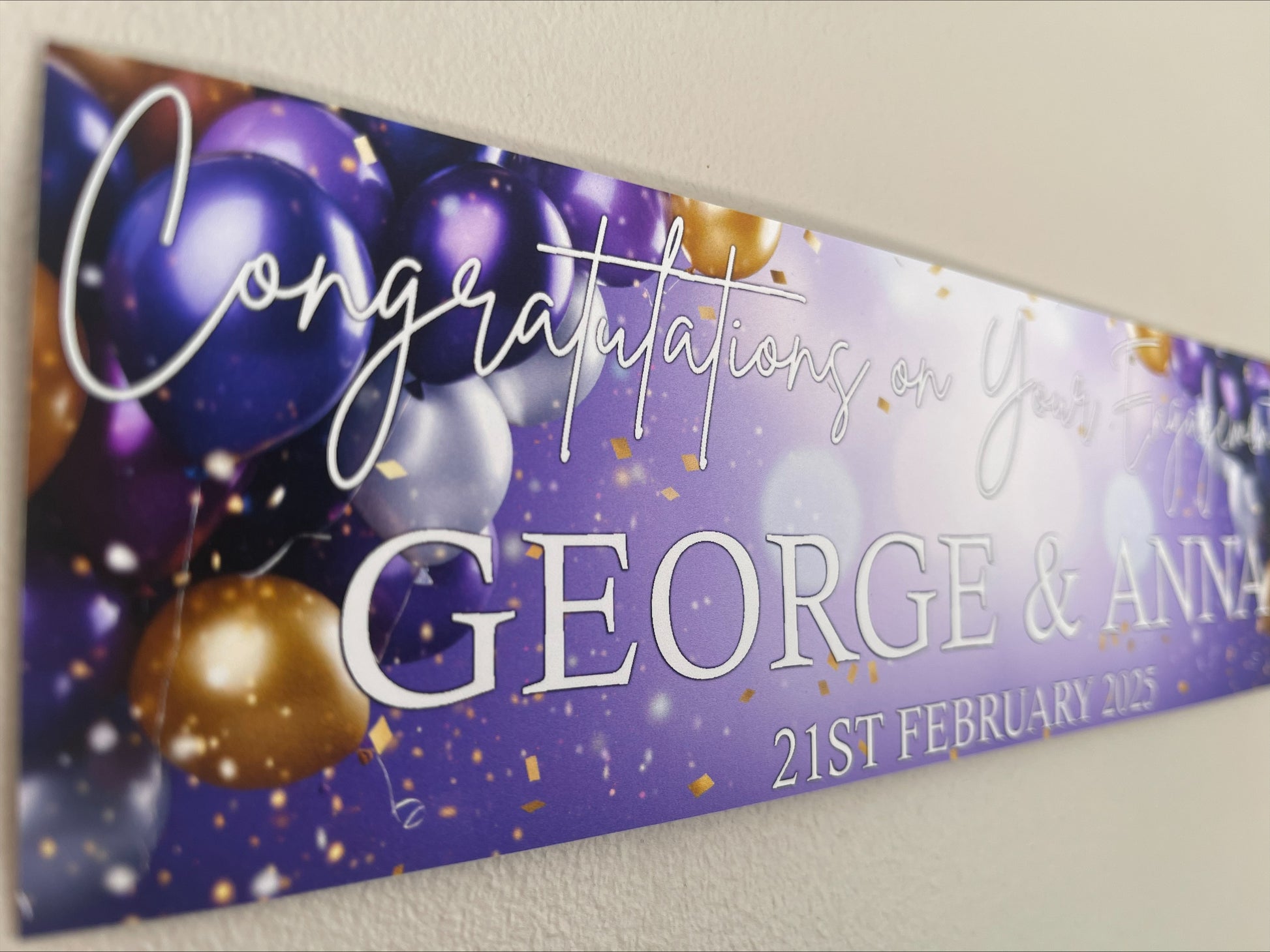 Engagement Banner in purple and gold with white text, personalised with names and date