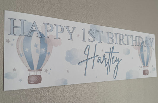 in the sky 1st birthday banner in blue personalised with happy 1st birthday and name