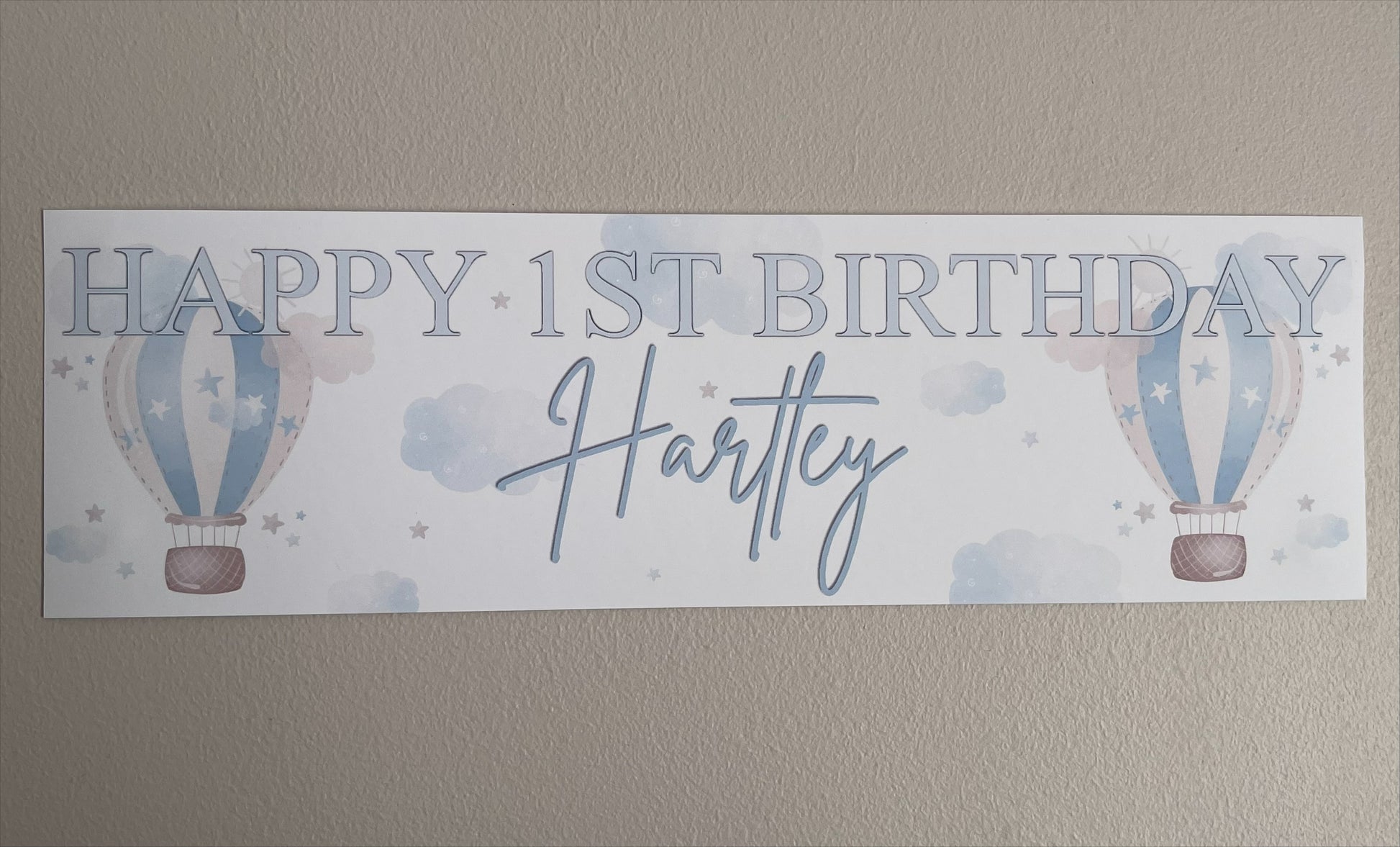 in the sky 1st birthday banner in blue personalised with happy 1st birthday and name