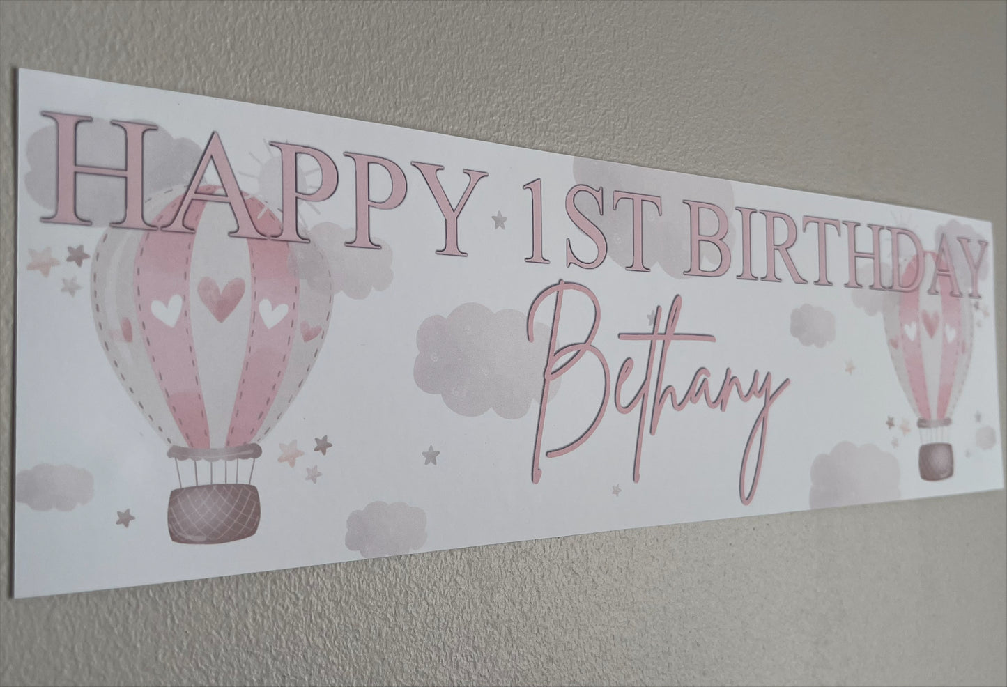 in the sky 1st birthday banner in pink personalised with happy 1st birthday and name
