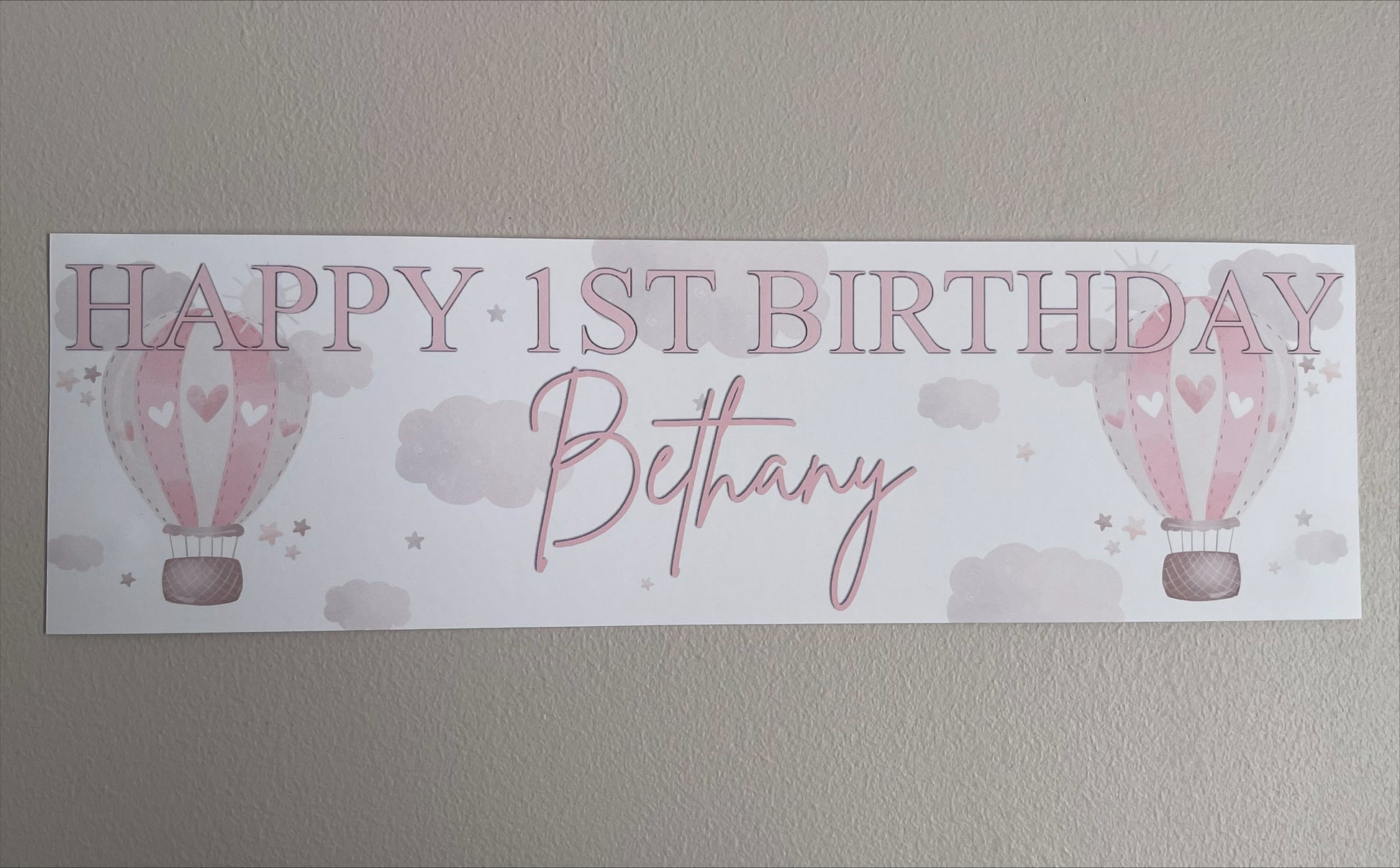 in the sky 1st birthday banner in pink personalised with happy 1st birthday and name